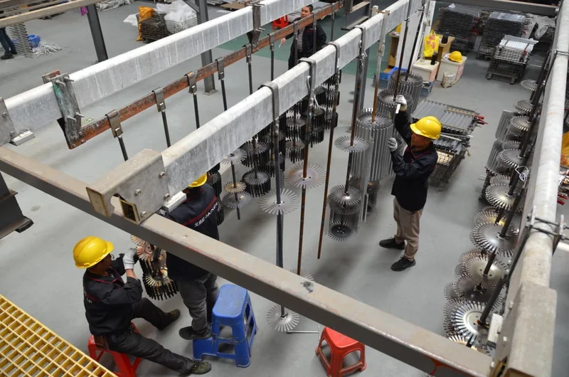 Operators working with components on the Gainer anodising line