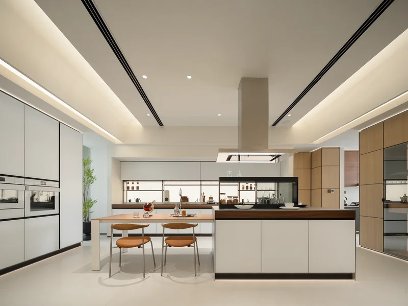 Light kitchen design with an island, warm timber accents and slim-framed glass storage cabinets