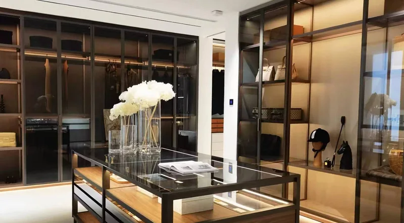 Glass wardrobe cabinets and a storage island in a past Gainer interior project
