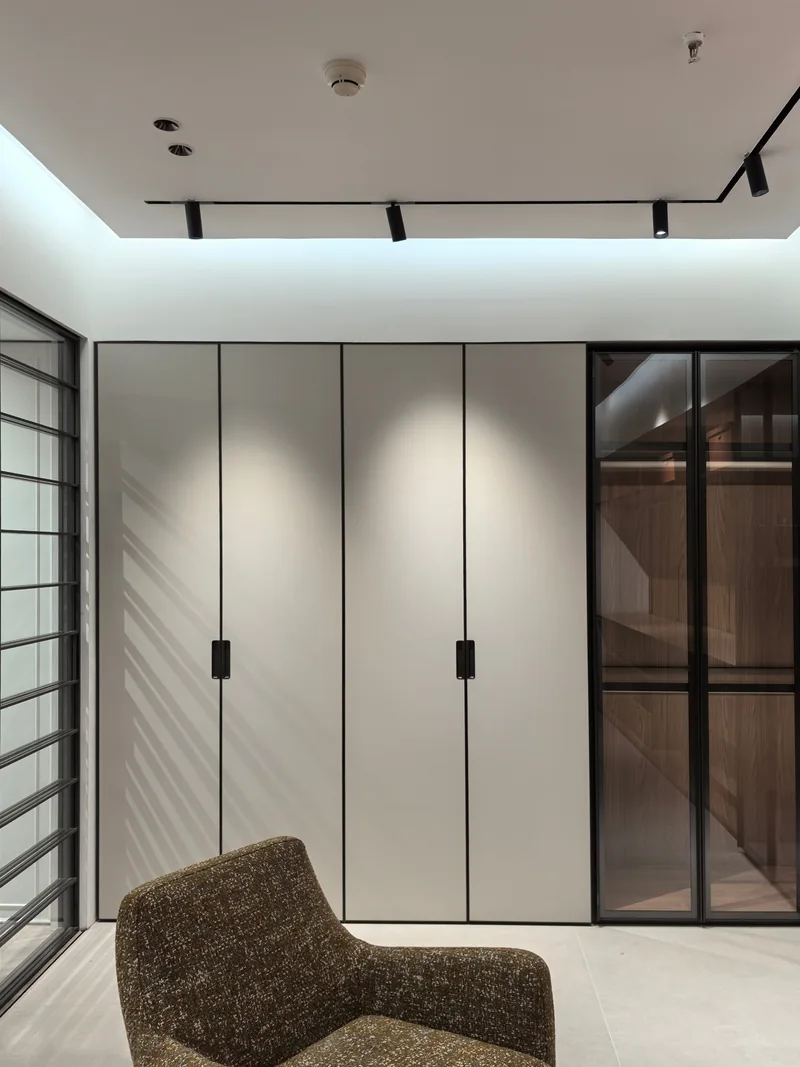 Solid wardrobe fronts beside glazed storage in a past Gainer wardrobe project